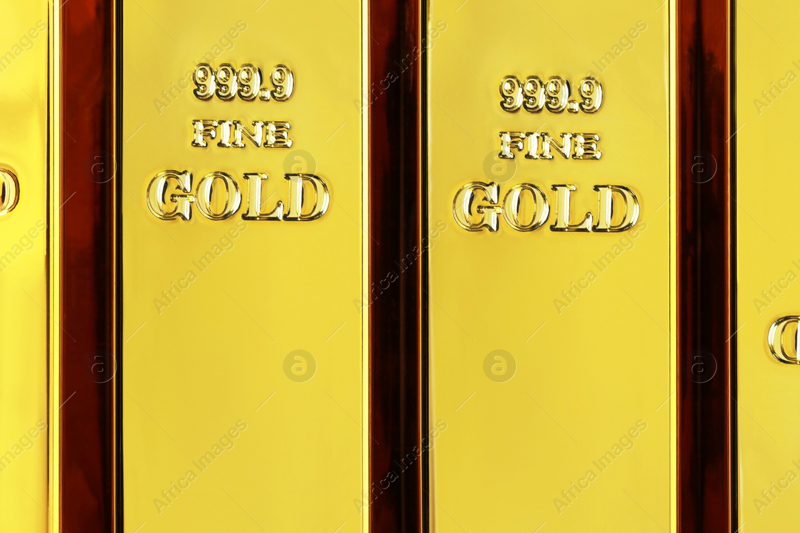 Photo of Many shiny gold bars as background, top view