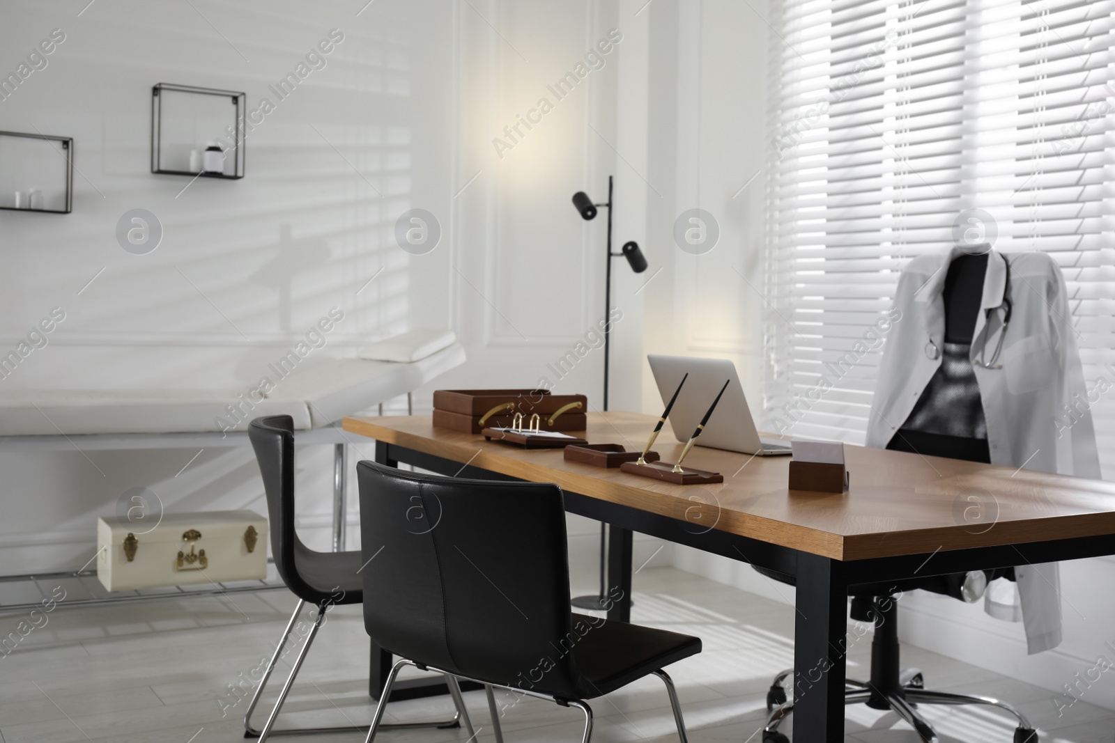 Photo of Modern medical office interior with doctor's workplace