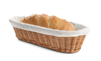 Sliced tasty fresh bread in wicker basket on white background