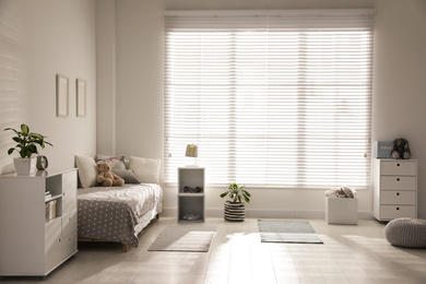 Photo of Modern child room interior with comfortable bed