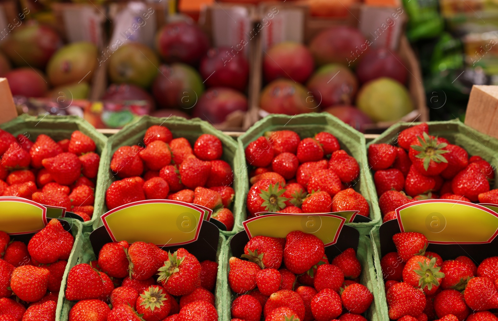 Photo of Many fresh strawberries in containers at wholesale market