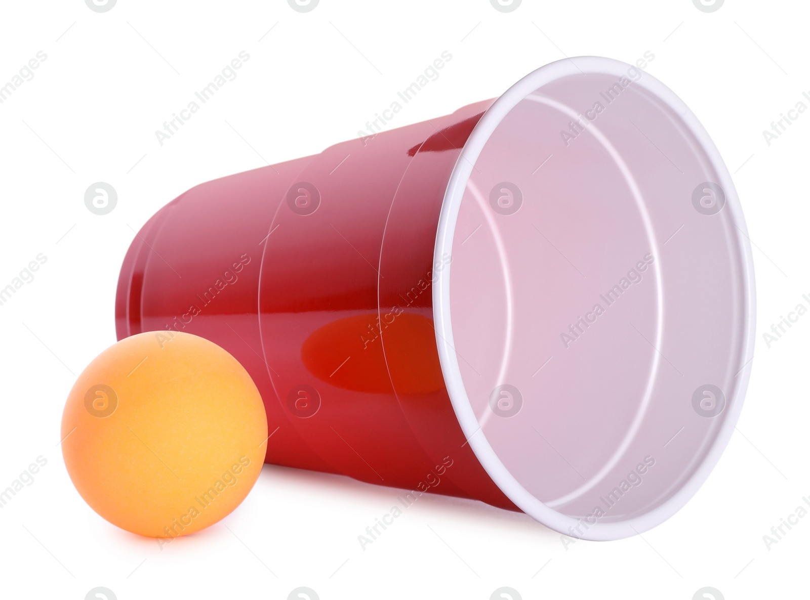 Photo of Plastic cup and ball for beer pong on white background