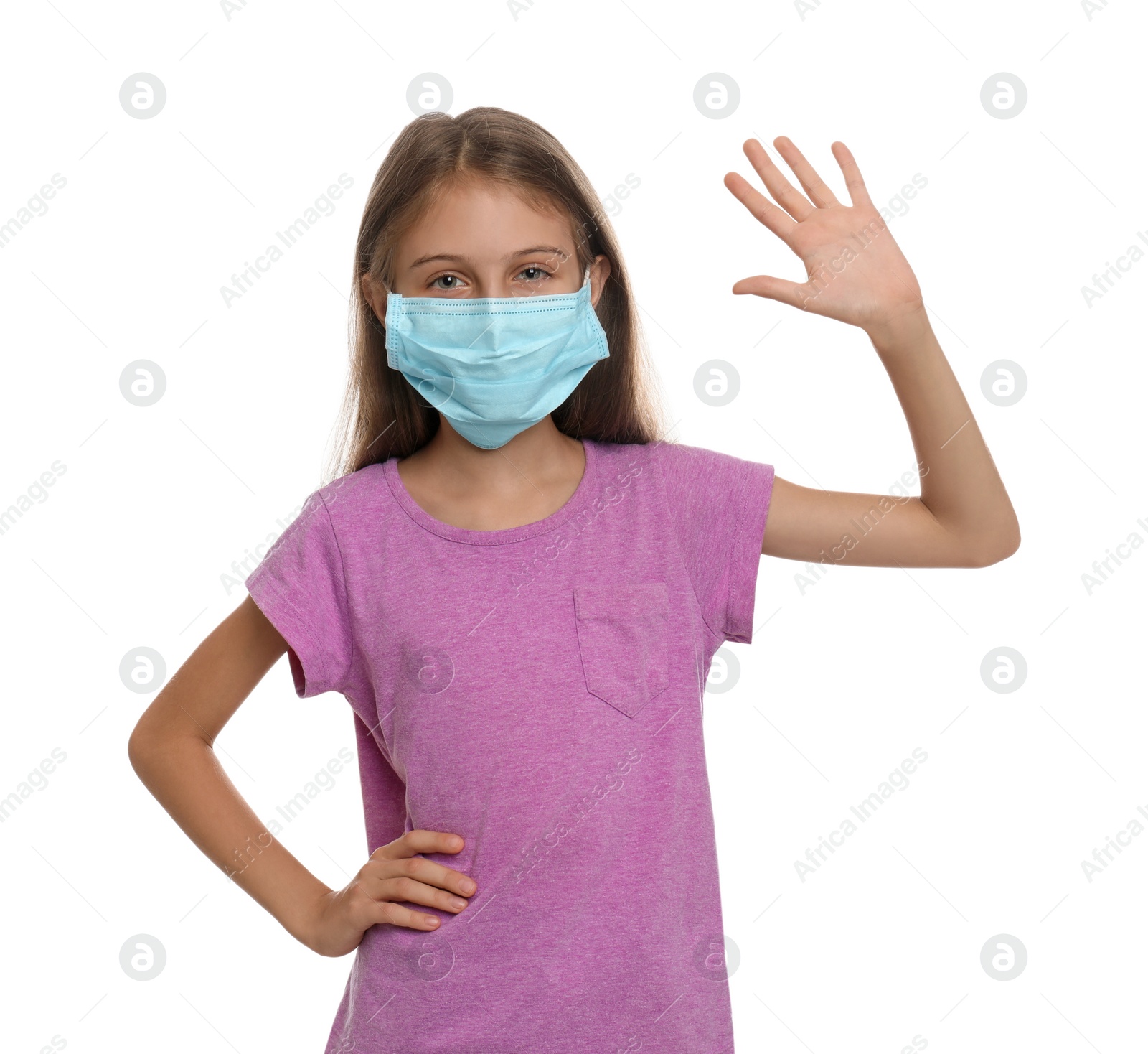 Photo of Little girl in protective mask showing hello gesture on white background. Keeping social distance during coronavirus pandemic