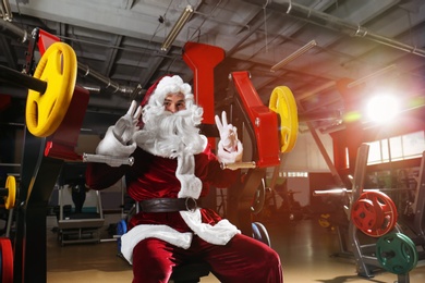 Young Santa Claus training in modern gym