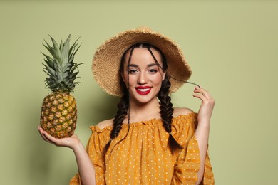 Young woman with fresh pineapple on olive background. Exotic fruit