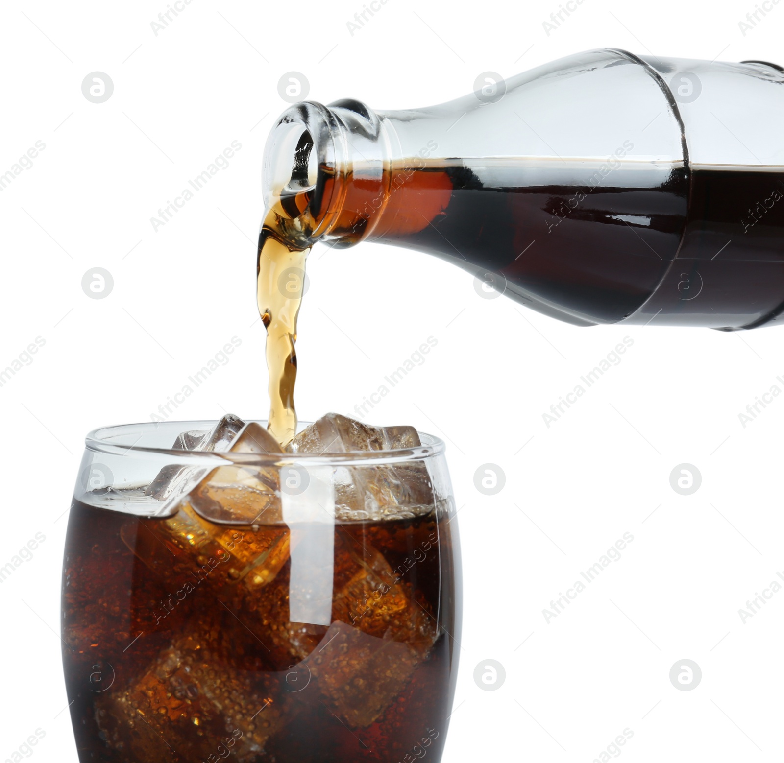 Photo of Pouring cola from bottle into glass with ice cubes on white background, closeup. Refreshing soda water