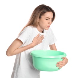 Photo of Woman with basin suffering from nausea on white background. Food poisoning