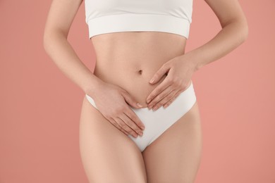 Photo of Gynecology. Woman in underwear on pink background, closeup