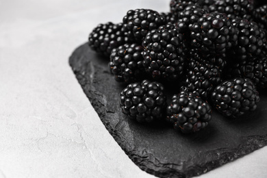 Fresh ripe blackberries on white table, closeup