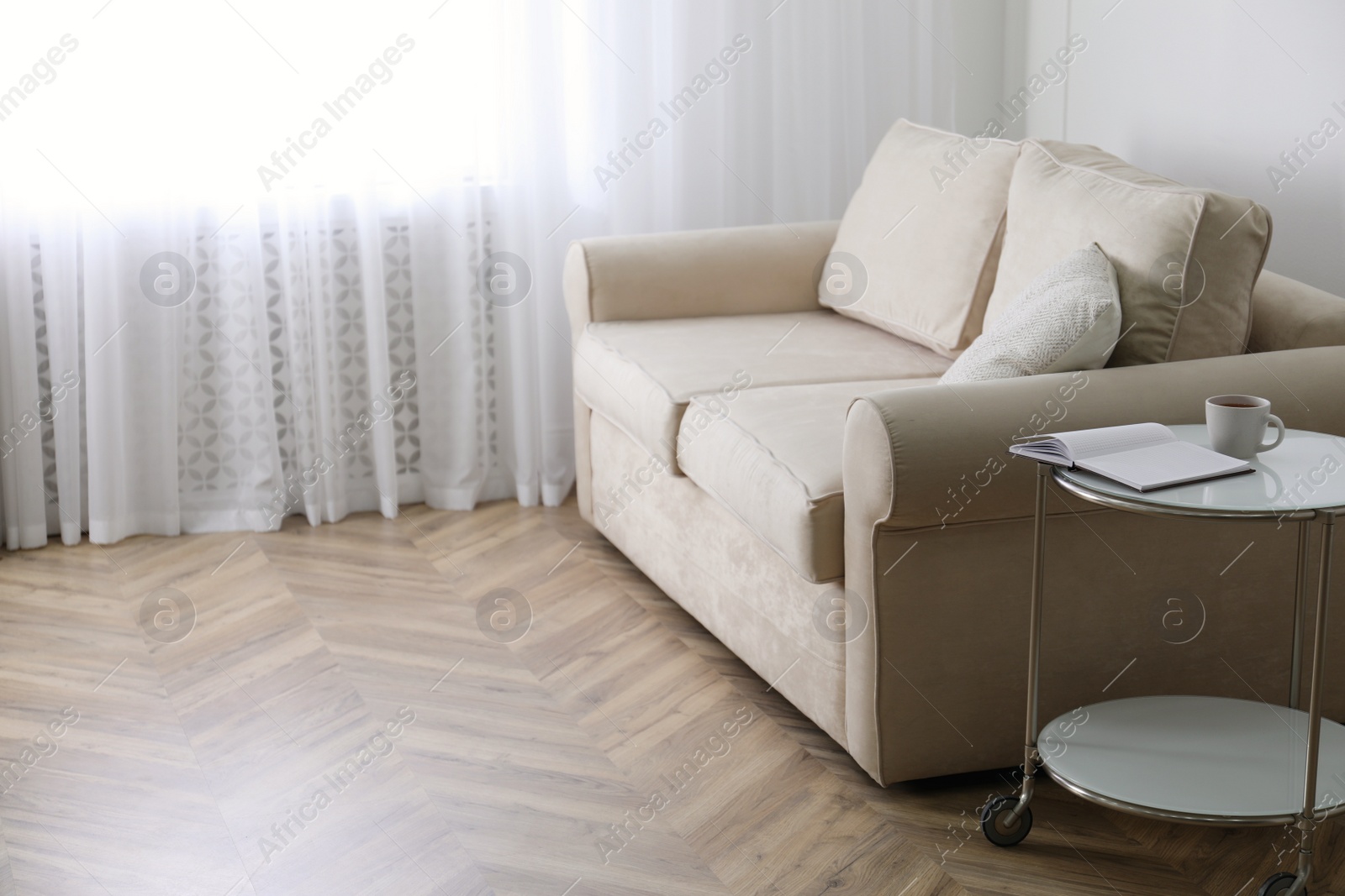 Photo of Parquet floor in room with sofa and coffee table