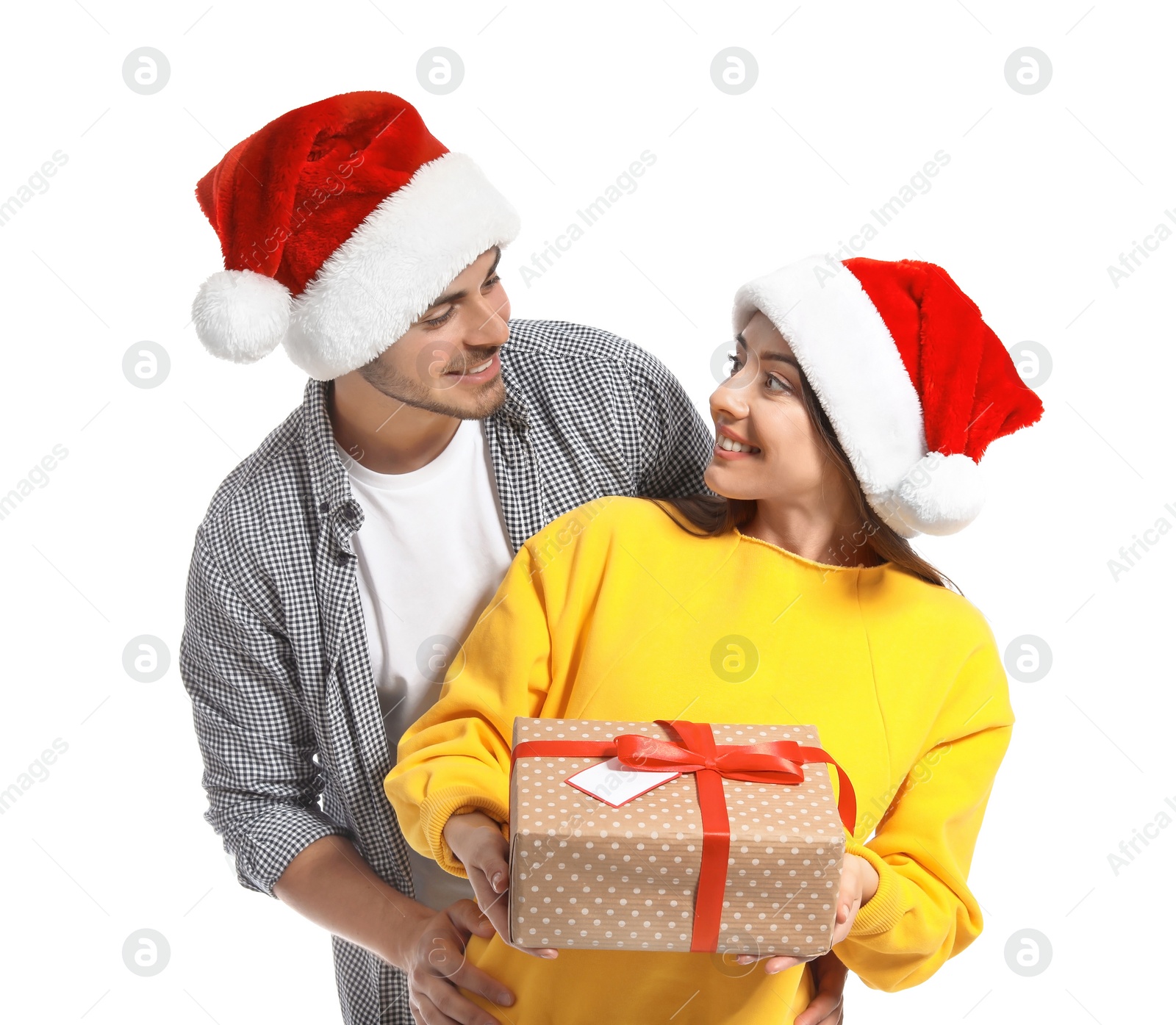 Photo of Young couple with Christmas gift on white background