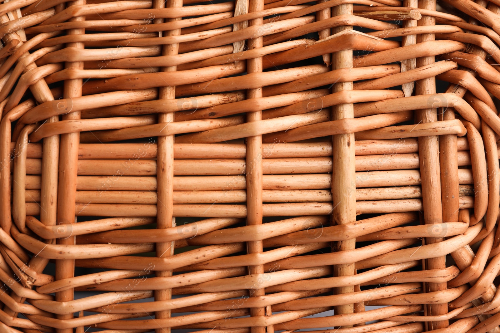 Photo of Handmade wicker basket made of natural material as background, closeup view