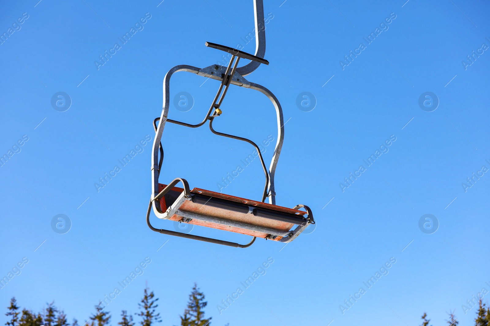 Photo of Empty chairlift at mountain ski resort. Winter vacation