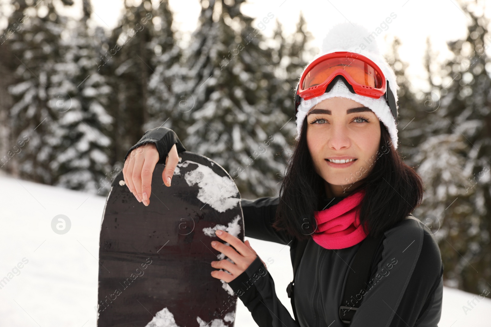 Photo of Young snowboarder wearing winter sport clothes outdoors