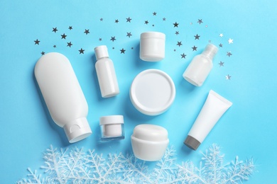 Photo of Set of cosmetic products on blue background, flat lay. Winter care