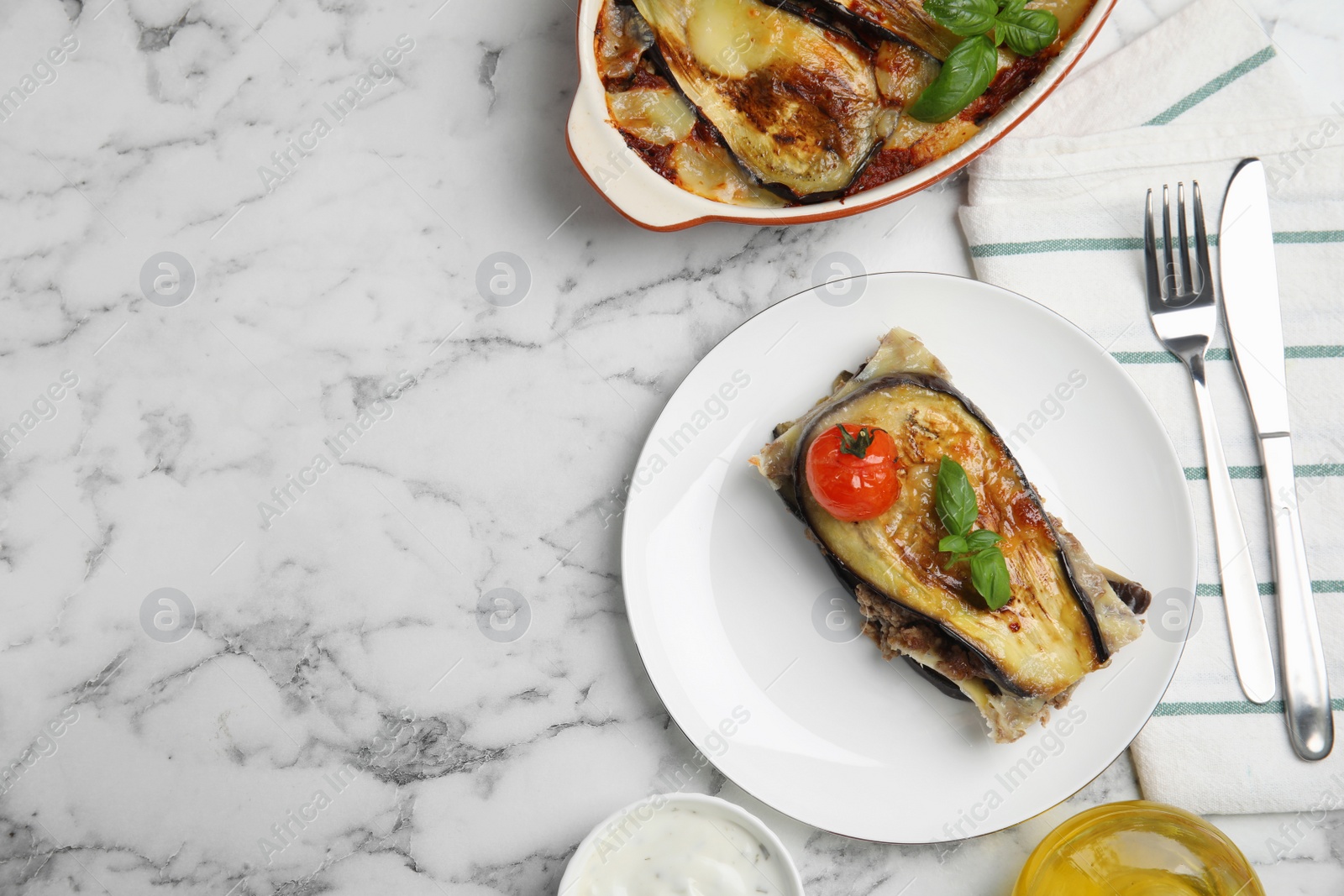 Photo of Delicious eggplant lasagna served on white marble table, flat lay. Space for text