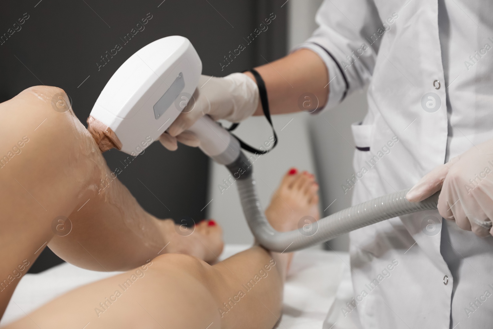 Photo of Woman undergoing laser epilation procedure in beauty salon, closeup