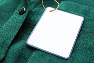 Blank tag on shirt, closeup view. Space for text