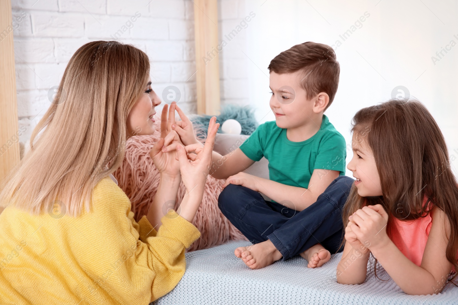 Photo of Nanny and little children playing at home