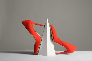 Photo of Composition with elegant female shoes on table against grey background