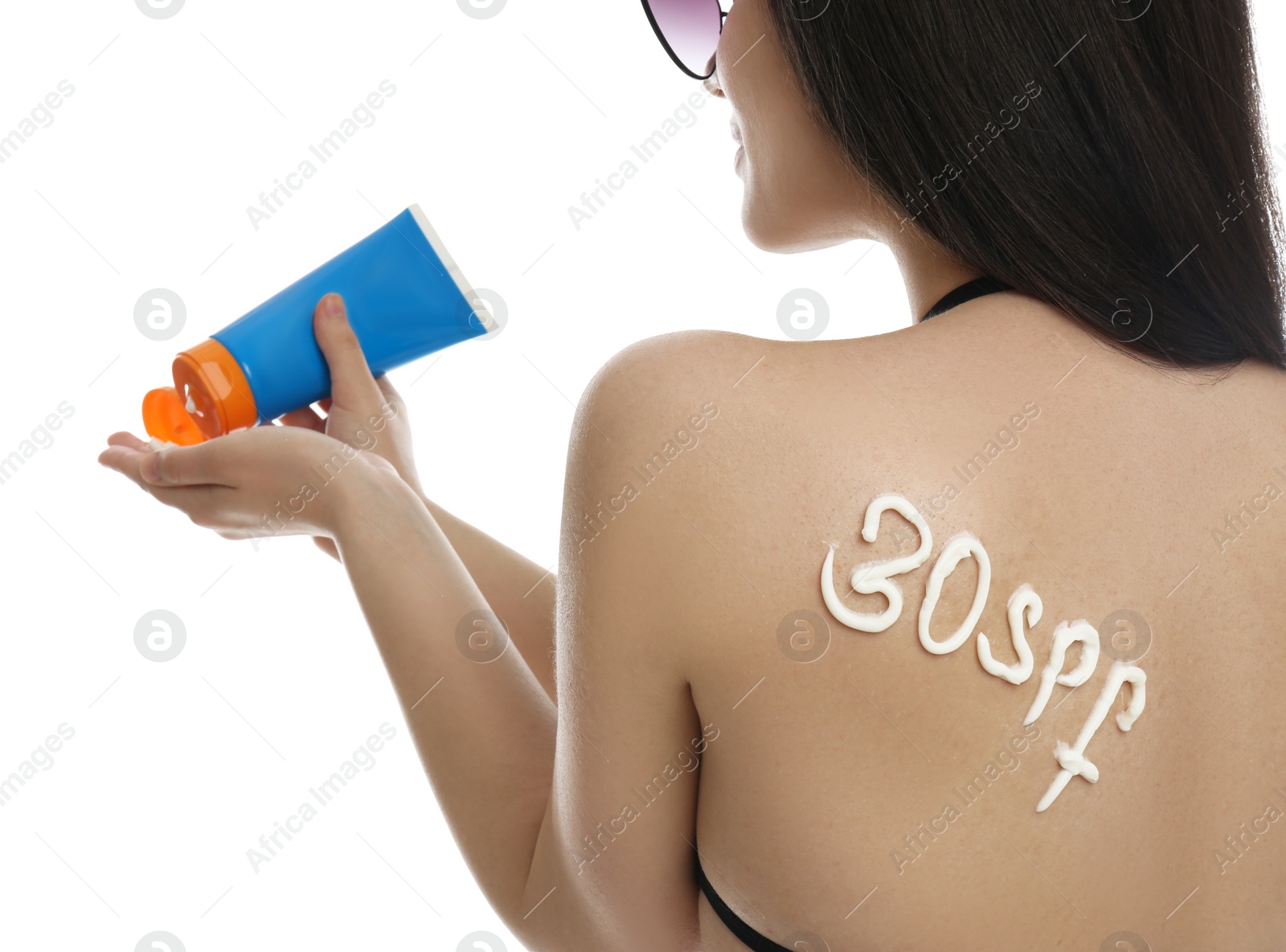 Photo of Text 30 SPF written with sun protection cream on woman's back against white background, closeup