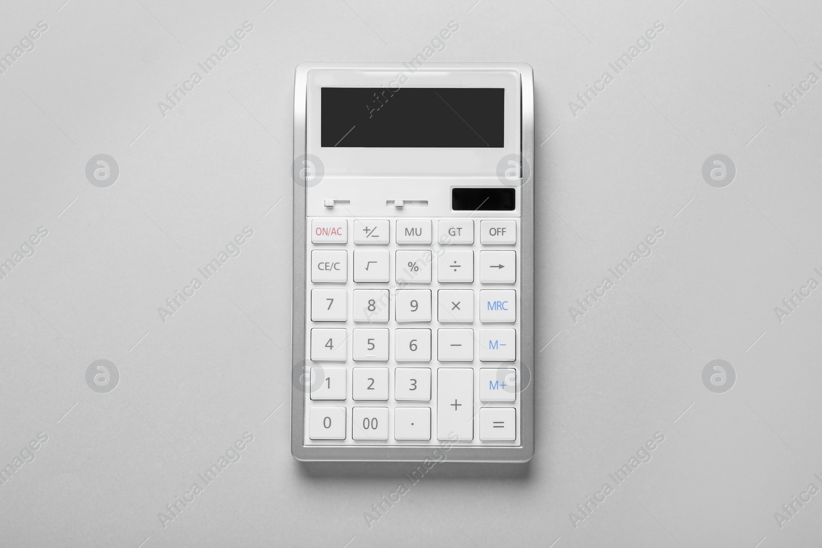 Photo of White calculator on light background, top view