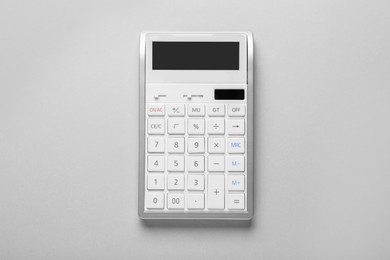 White calculator on light background, top view