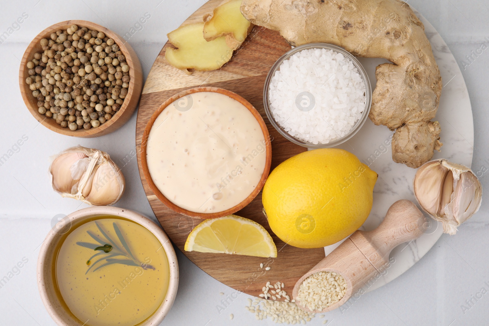 Photo of Flat lay composition with fresh marinade and different ingredients on white tiled table