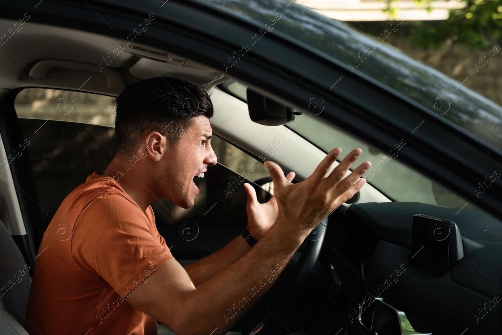 Photo of Stressed man in driver's seat of modern car