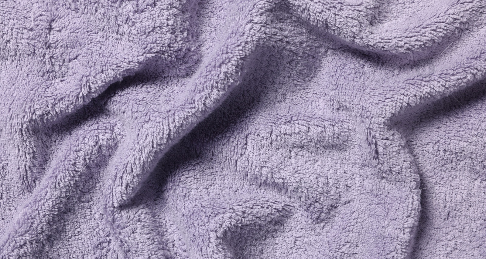 Photo of Texture of soft violet crumpled fabric as background, top view