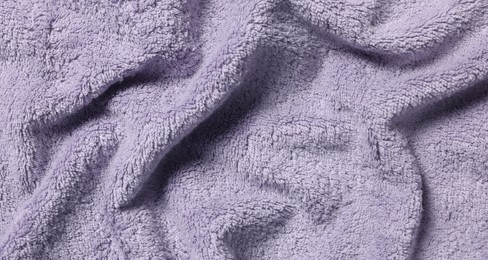 Texture of soft violet crumpled fabric as background, top view