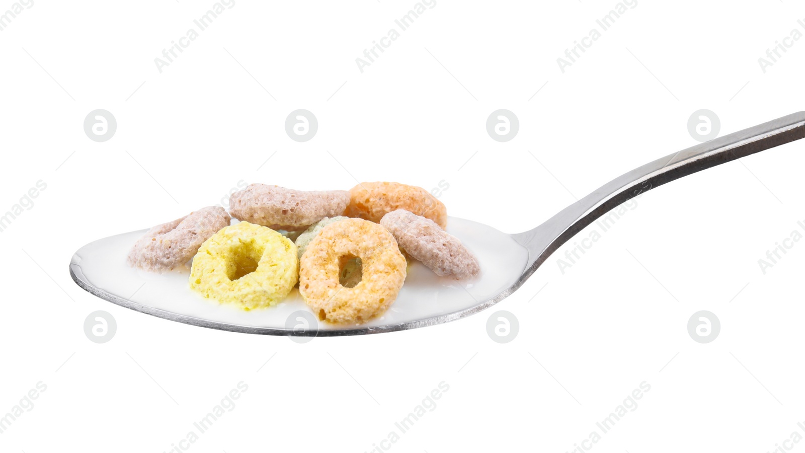 Photo of Cereal rings and milk in spoon isolated on white