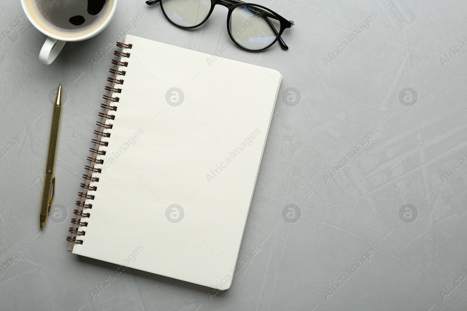 Photo of Flat lay composition with open notebook on light textured table. Space for text