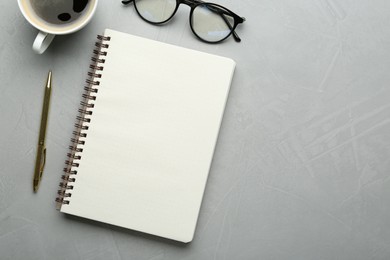 Flat lay composition with open notebook on light textured table. Space for text