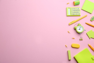 Photo of Bright school stationery on pink background, flat lay. Space for text