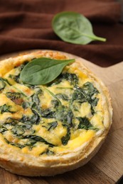 Photo of Delicious pie with spinach on table, closeup