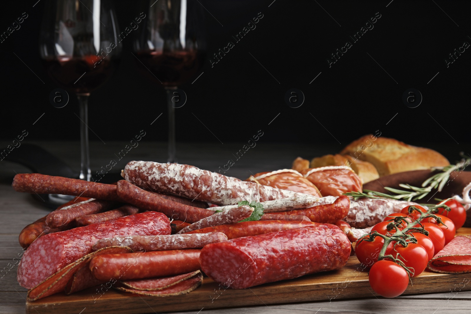 Photo of Different tasty sausages on wooden table, closeup