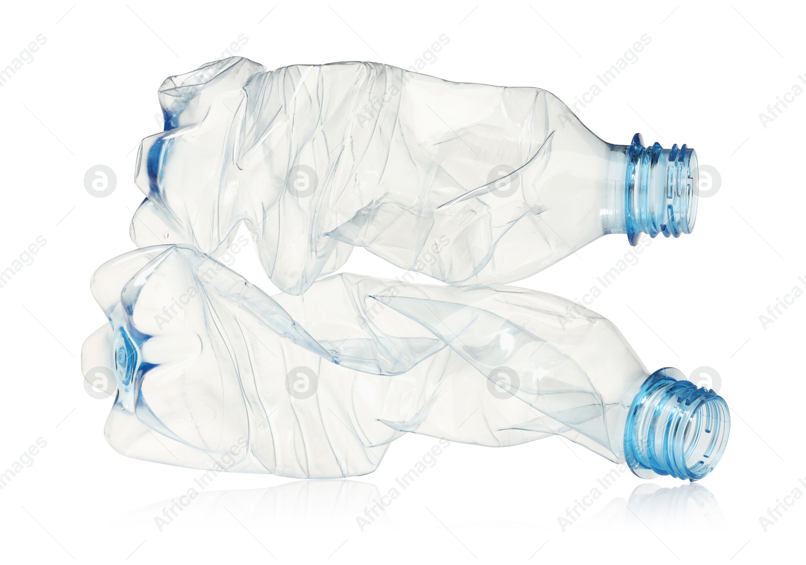 Photo of Crumpled disposable plastic bottles isolated on white