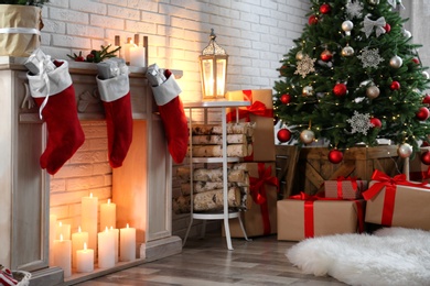 Photo of Festive room interior with decorative fireplace and Christmas tree