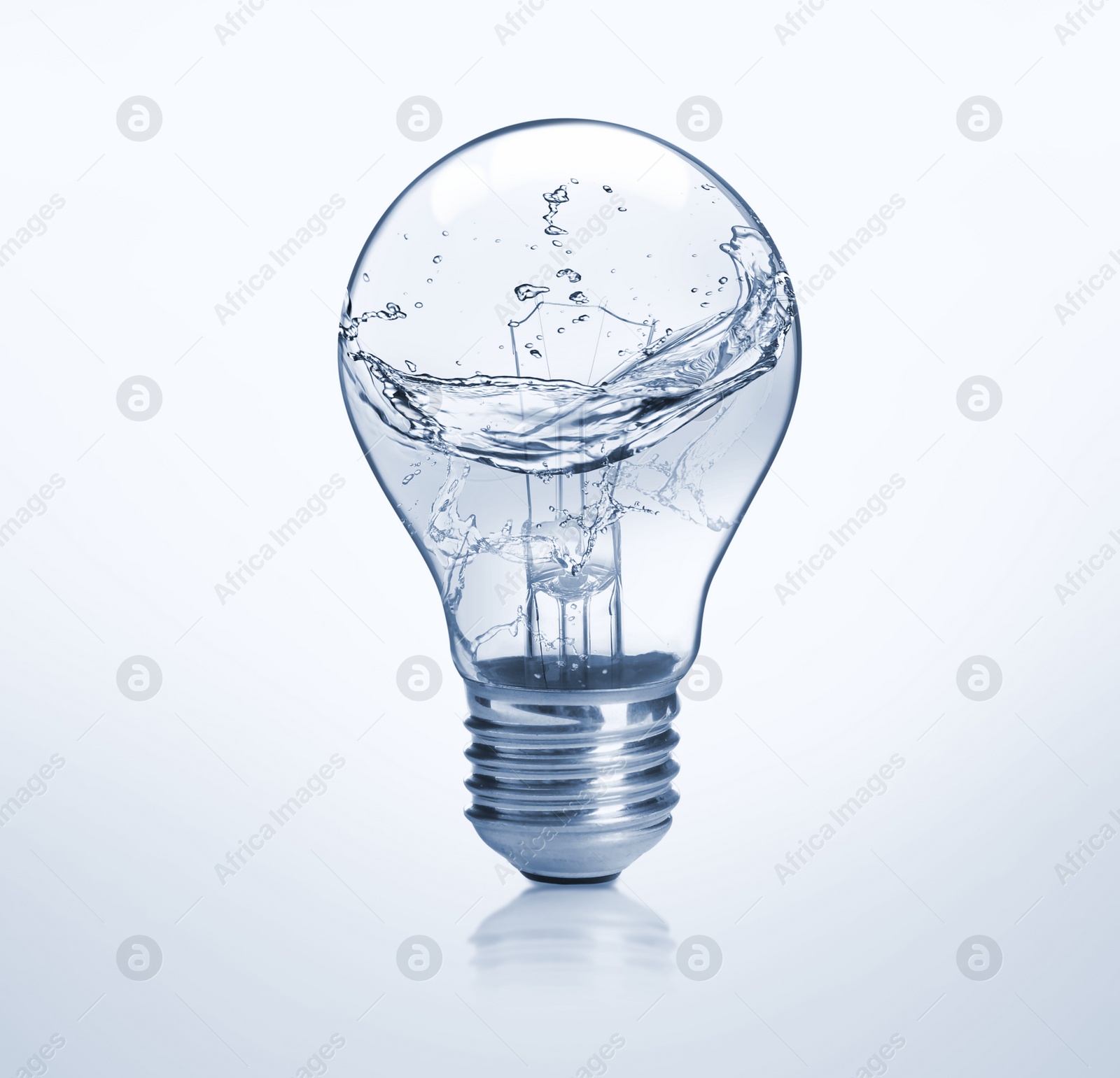 Image of Light bulb with water splashes on light background. Alternative energy source