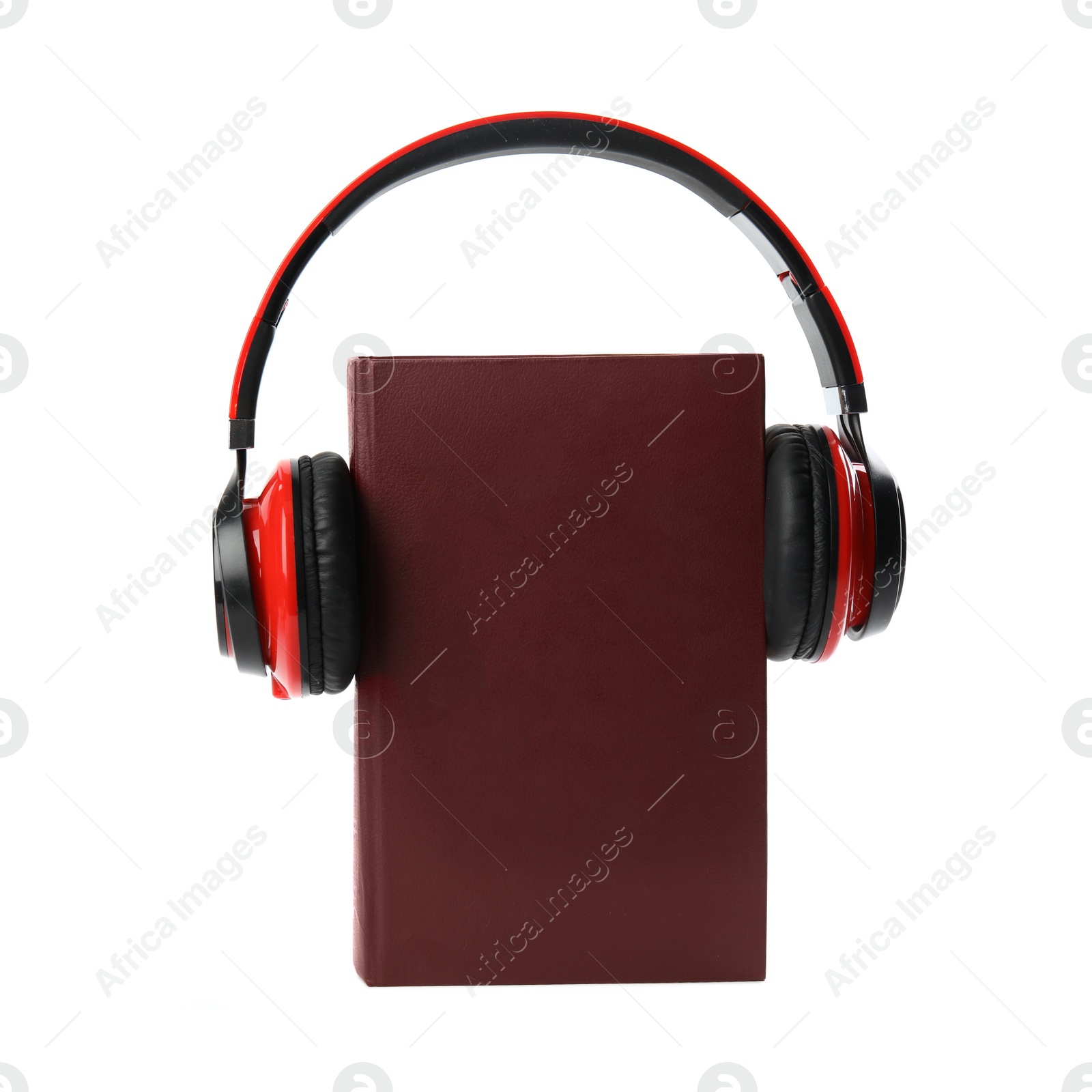 Photo of Book and modern headphones isolated on white