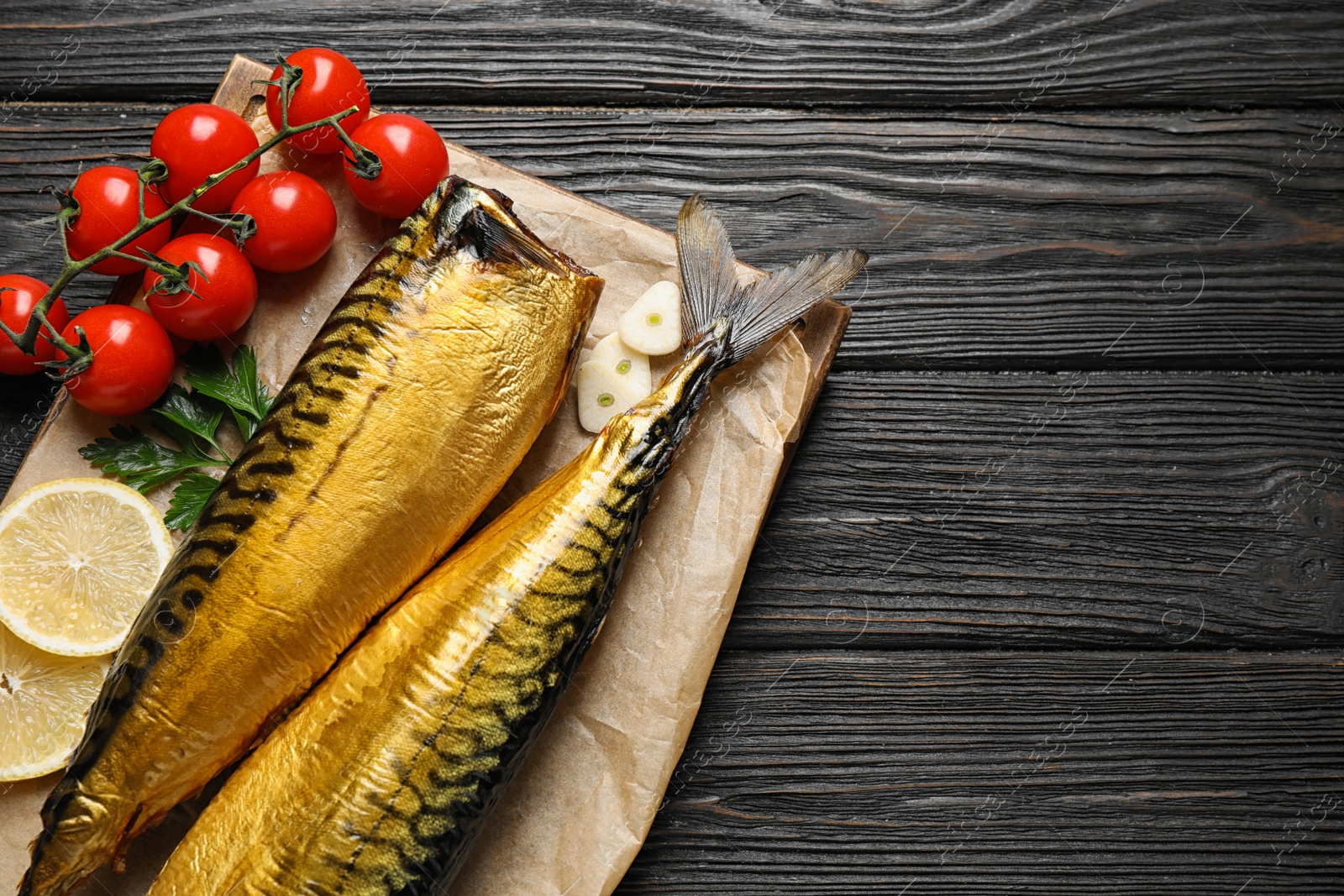 Photo of Tasty smoked fish on wooden table, top view