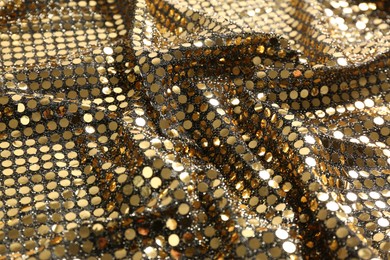 Photo of Closeup view of golden shiny sequin fabric as background