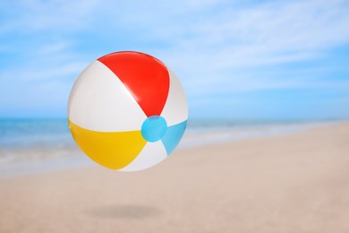 Image of Colorful inflatable beach ball and seascape on background