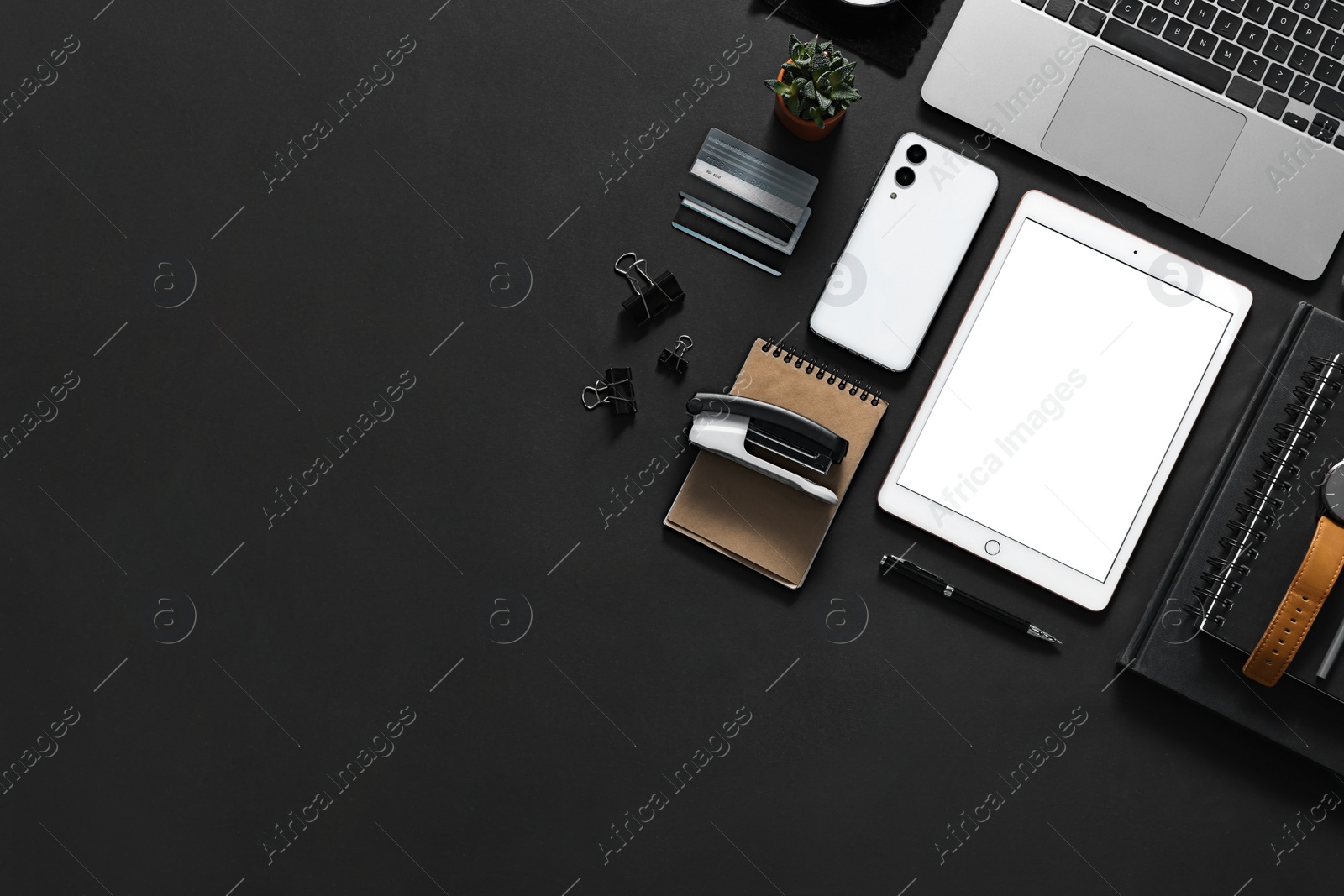 Photo of Flat lay composition with modern tablet on black background. Space for text