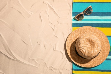 Flat lay composition with beach objects and space for text on sand