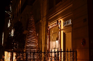 Photo of Paris, France - December 10, 2022: Christian Dior store exterior with Christmas decor at night
