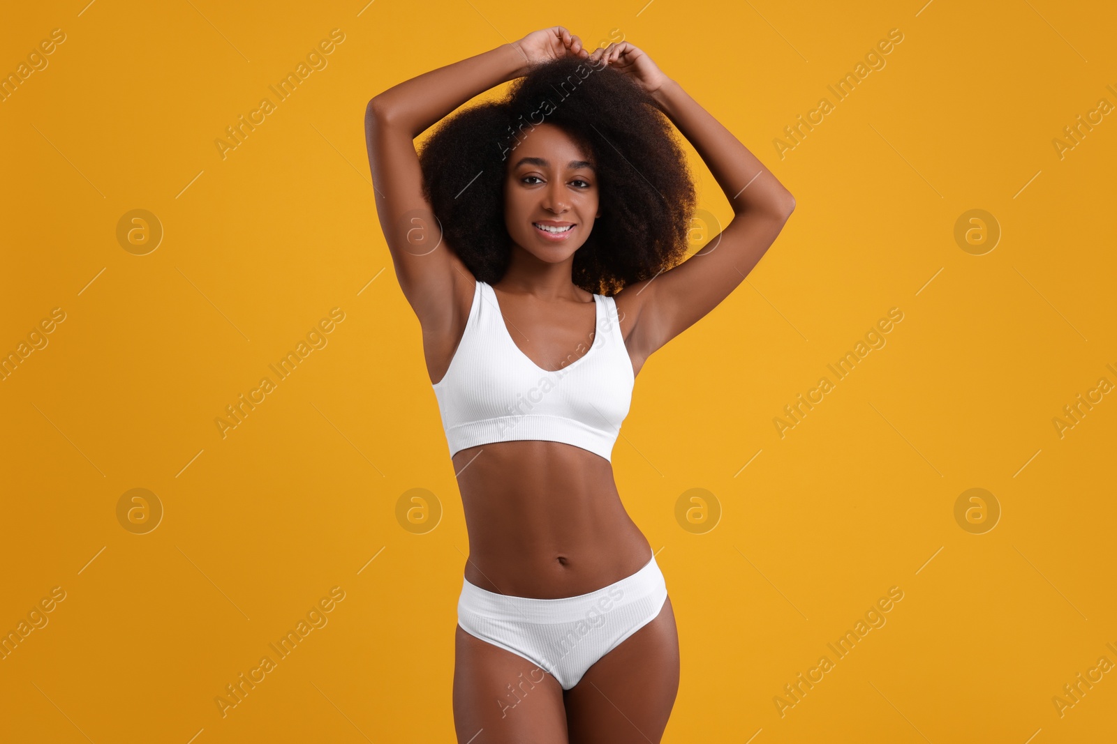 Photo of Beautiful woman in stylish bikini on yellow background