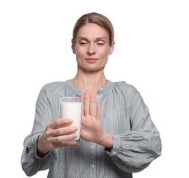 Woman with glass of milk suffering from lactose intolerance on white background