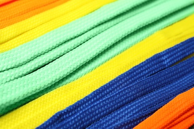 Photo of Colorful shoelaces as background, closeup. Stylish accessory